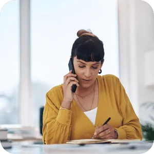 Woman on phone looking at paperwork